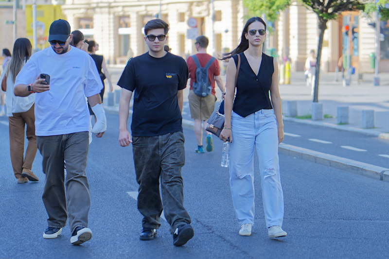 15 - Three young people casually walking down a city street in Bucharest on a sunny day